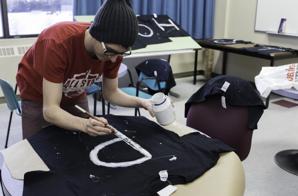 Un étudiant prépare les chandails de l'équipe du programme de photographie en vue des Olympiades de la vie active, une compétition amicale qui regroupes l'ensemble des programmes du Cégep de Matane. — Olivia Simard